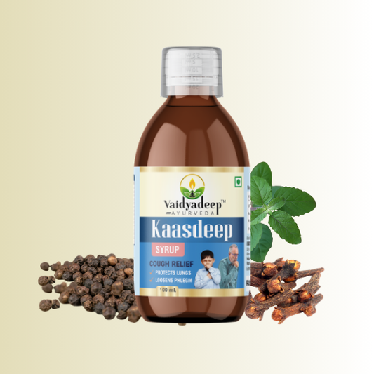 Bottle of Vaidyadeep Kaasdeep syrup with peppercorns and clove on a beige background